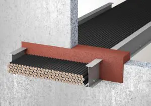 A bundle of cables passes through a fire barrier in a wall, sealed with fireproof material using UL firestop systems.
