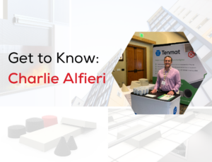Man in a pink shirt stands at a Tenmat booth with display items; text reads Get to Know: Charlie Alfieri.