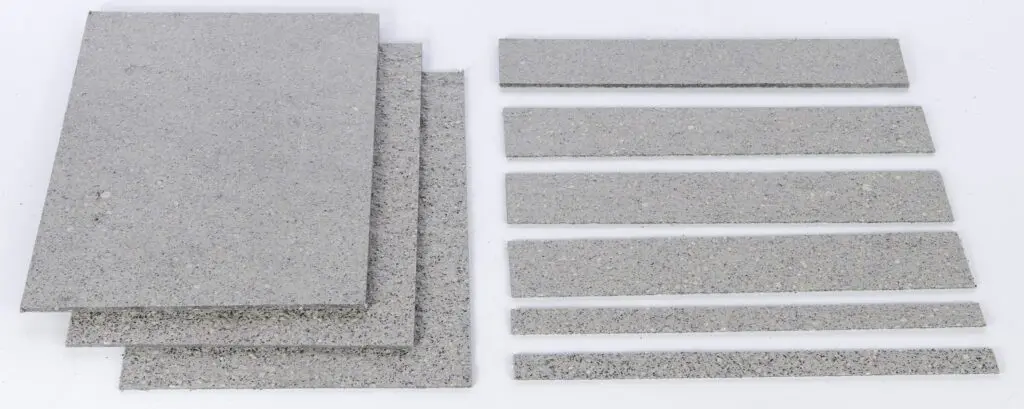 Four rectangular gray stone slabs and six narrow stone strips on a white background.