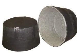 Two black crucibles, one upright and one lying on its side, display their inner and outer surfaces alongside high hat covers.