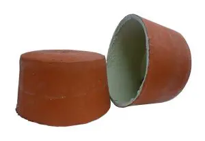 Two orange conical clay lids, one lying flat and the other resting on its side, revealing the inner surface—perfect for complementing a 2 hour fire rated ceiling installation.