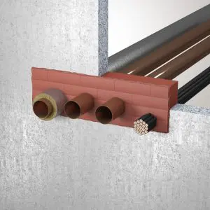 Brick wall with four pipes and a cable bundle passing through openings, featuring UL firestop systems for enhanced safety.