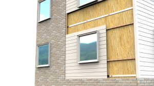 A building facade showing exposed insulation, fire barrier, and siding layers around a window.