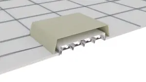 A cross-section of a tiled floor with a metal expansion joint covered by a rectangular cap.