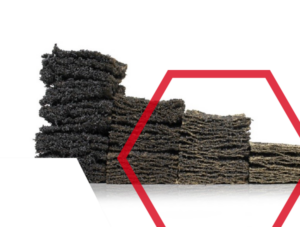 Stacked dark porous blocks with rough texture, partly framed by a red hexagon on a white background.