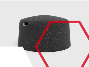 A dark gray, hexagonal stool with a small side handle, overlaid by a red outlined hexagon shape.