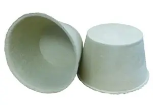 Two biodegradable seed starter pots, one upright and one lying on its side, are displayed on a white background—ideal for starting plants near an attic recessed light cover or in any indoor garden space.