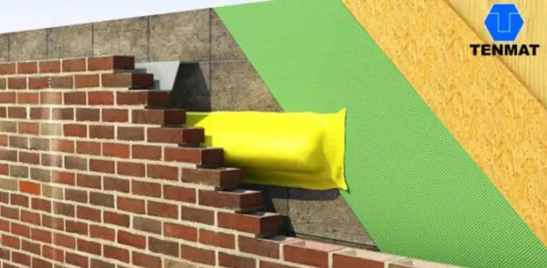 A yellow TENMAT cavity barrier installed in a brick cavity wall, with the Tenmat logo in the top right corner, helps revolutionise fire protection.
